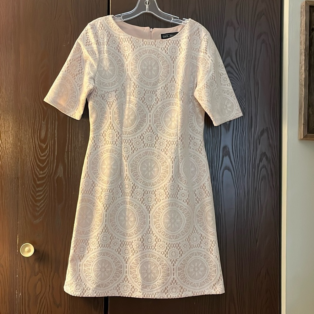 Karin Steven’s short sleeved ivory lace dress over a beige underlay. Size 14.